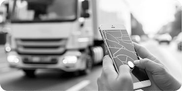 Smartphone displaying GPS navigation with truck on road in background